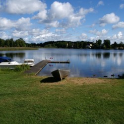 Badeplatz mit Boot am Freizeitheim Idrottsgården i Flen in Schweden.